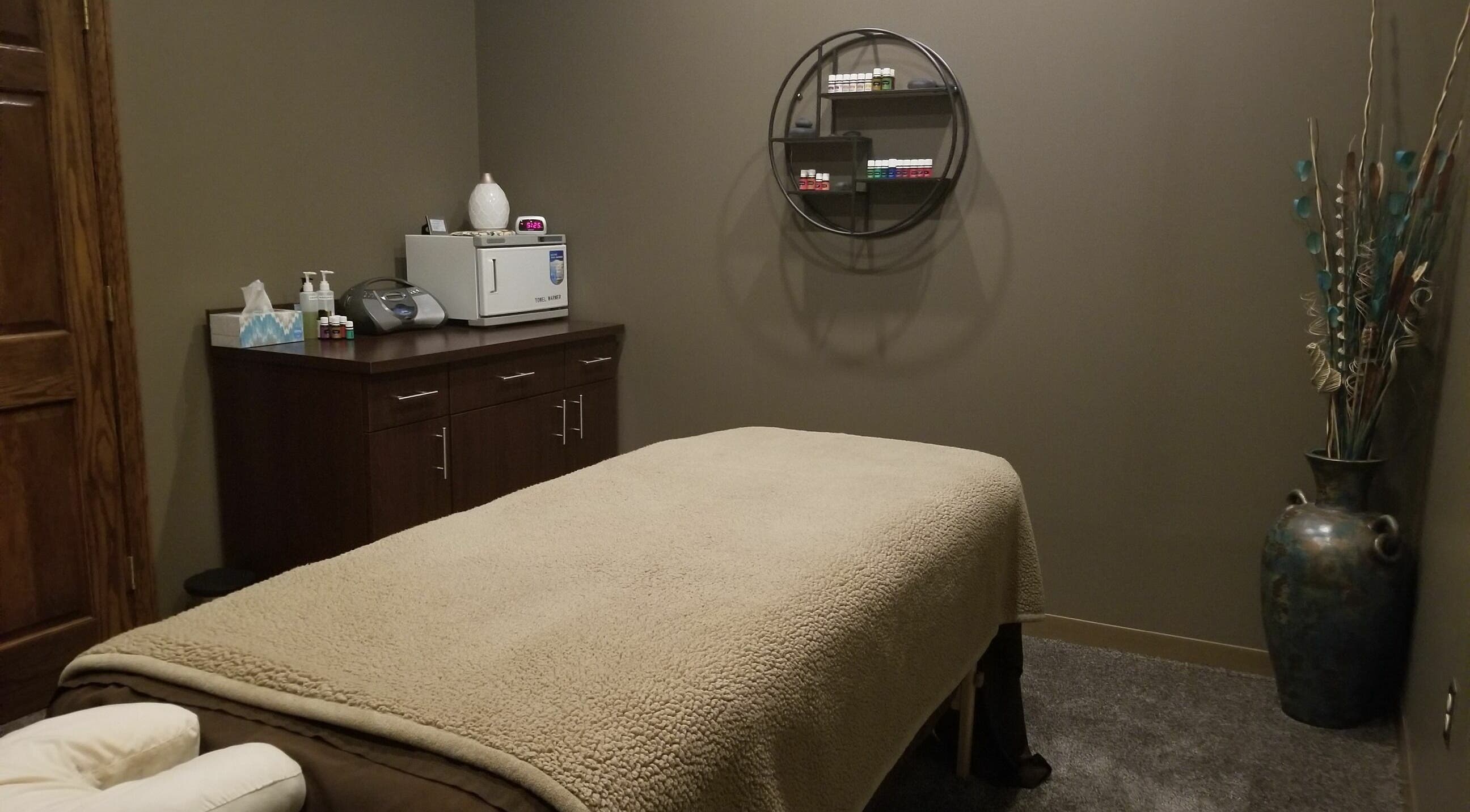 Relaxing treatment room at Indulge Salon and Spa, Grand Island, Nebraska, US, with a massage table and soothing decor.