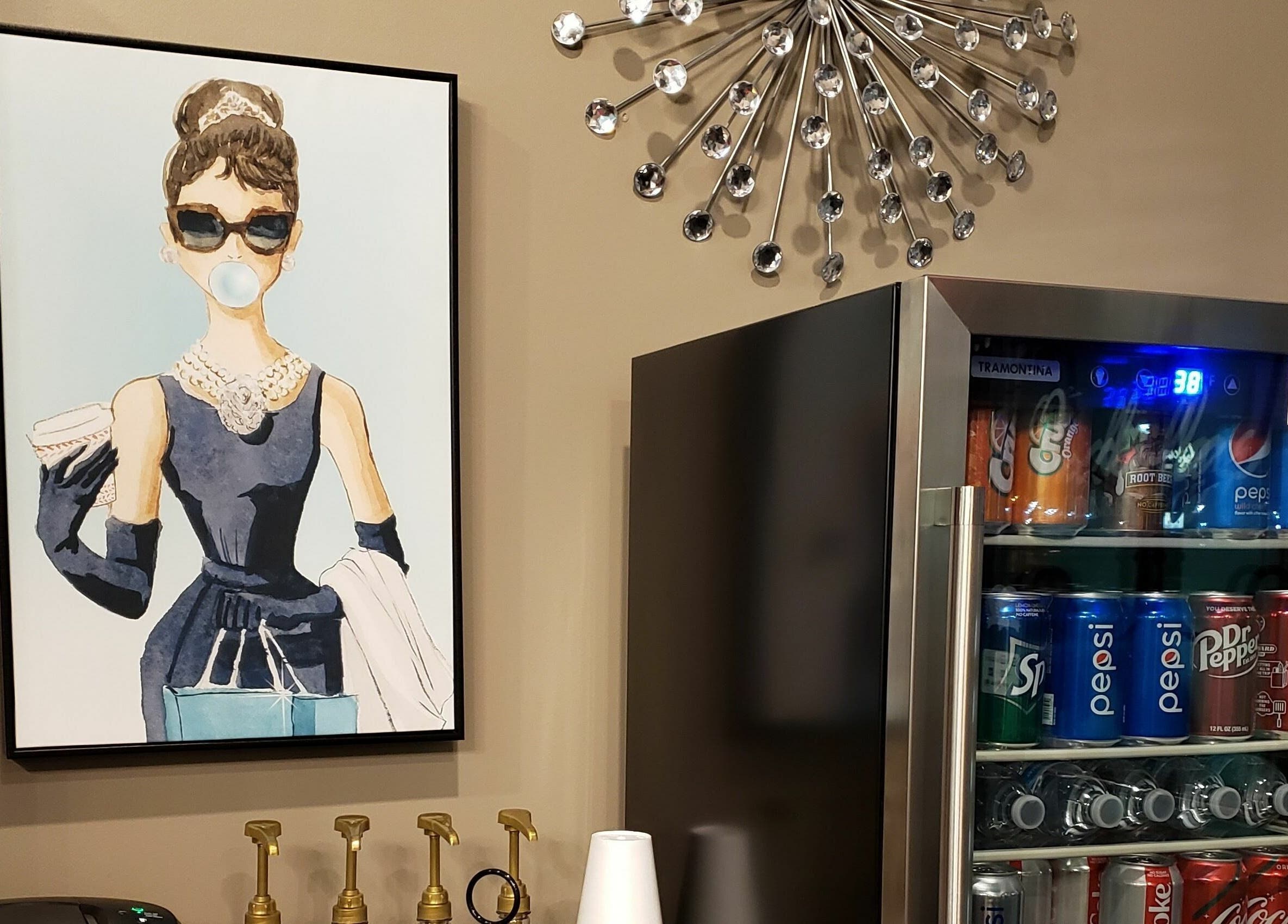 Stylish wall art and soda fridge at Indulge Salon and Spa, Grand Island, Nebraska, US.