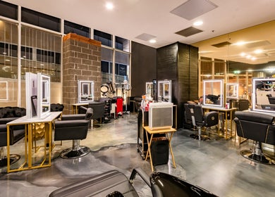 Modern interior of S Parlor Hair, Melbourne, Victoria, AU, showcasing stylish salon chairs and mirrors.