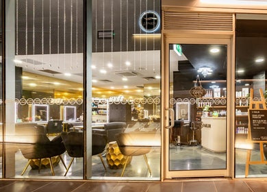 Elegant storefront of S Parlor Hair in Melbourne, Victoria, AU with modern chairs and stylish decor.