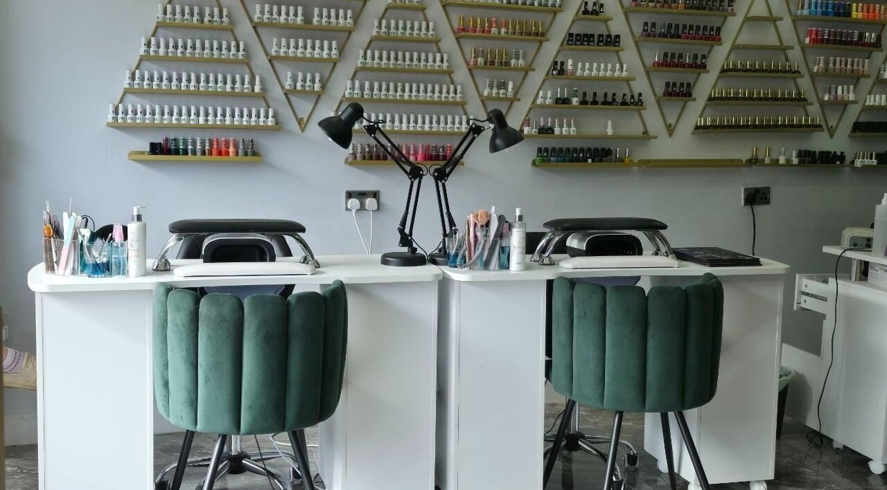 Chic nail station at Elle Beauty Bar, London, England, GB, with elegant polish display and comfy seating.