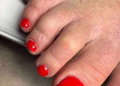 Vibrant red pedicure at The Rose Collection, Weston-super-Mare, England, GB, highlights expert nail care.