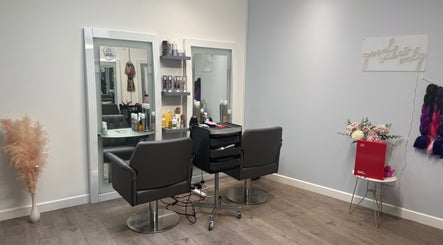 Modern salon interior at Hair by Jodie, Kilmarnock, Scotland, GB with stylish mirrors and chairs.