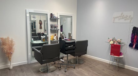 Modern salon setup at Hair by Jodie, Kilmarnock, Scotland, GB, featuring chic styling chairs and product displays.