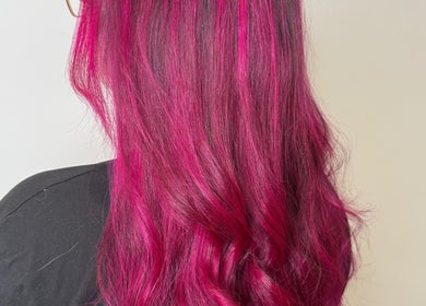 Bright magenta hair styled at Hair by Jodie, Kilmarnock, Scotland, GB showcasing vibrant color treatment.