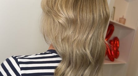 Blonde hair styled at Hair by Jodie, Kilmarnock, Scotland, GB. Elegant waves and flawless finish.