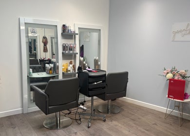 Modern salon interior at Hair by Jodie in Kilmarnock, Scotland, GB, featuring stylish decor and comfortable seating.