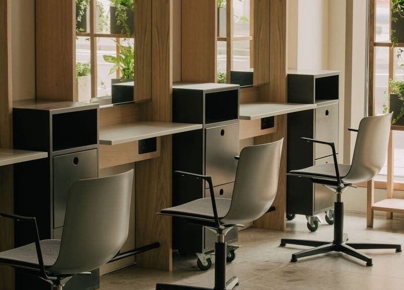 Elegant styling stations at Glasshouse Salon in London, England, GB with lush greenery and modern decor.