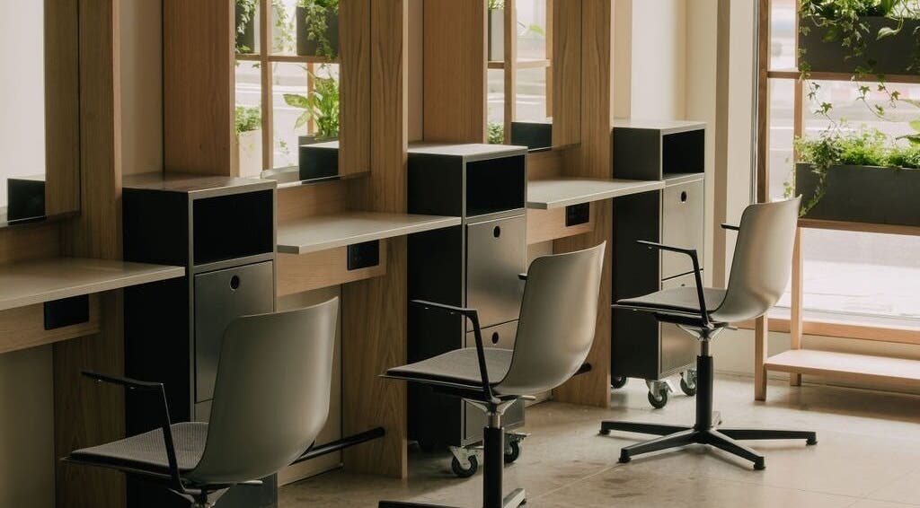 Elegant styling stations at Glasshouse Salon in London, England, GB with lush greenery and modern decor.