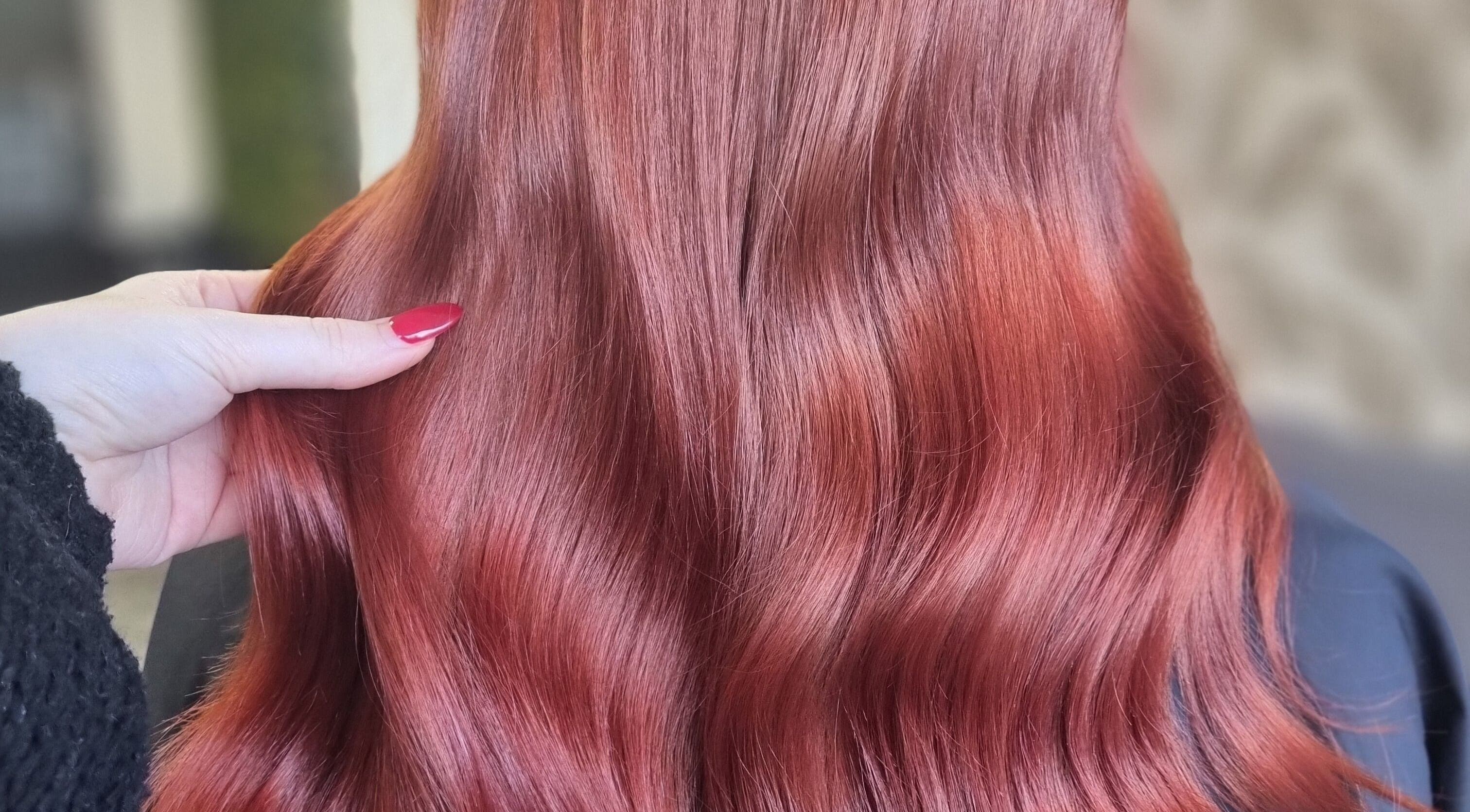 Vibrant red hair styled by Hair by Heather in Swindon, England, GB, showcasing a glossy finish.