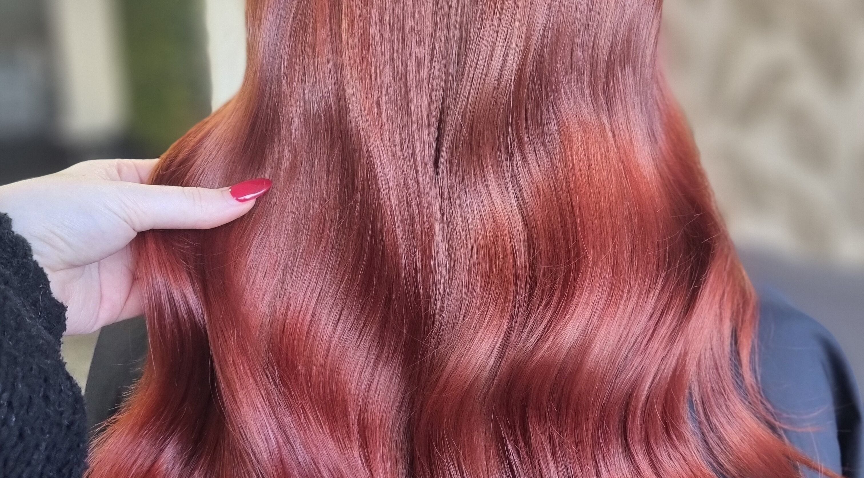 Vibrant red hair styled by Hair by Heather in Swindon, England, GB, showcasing a glossy finish.