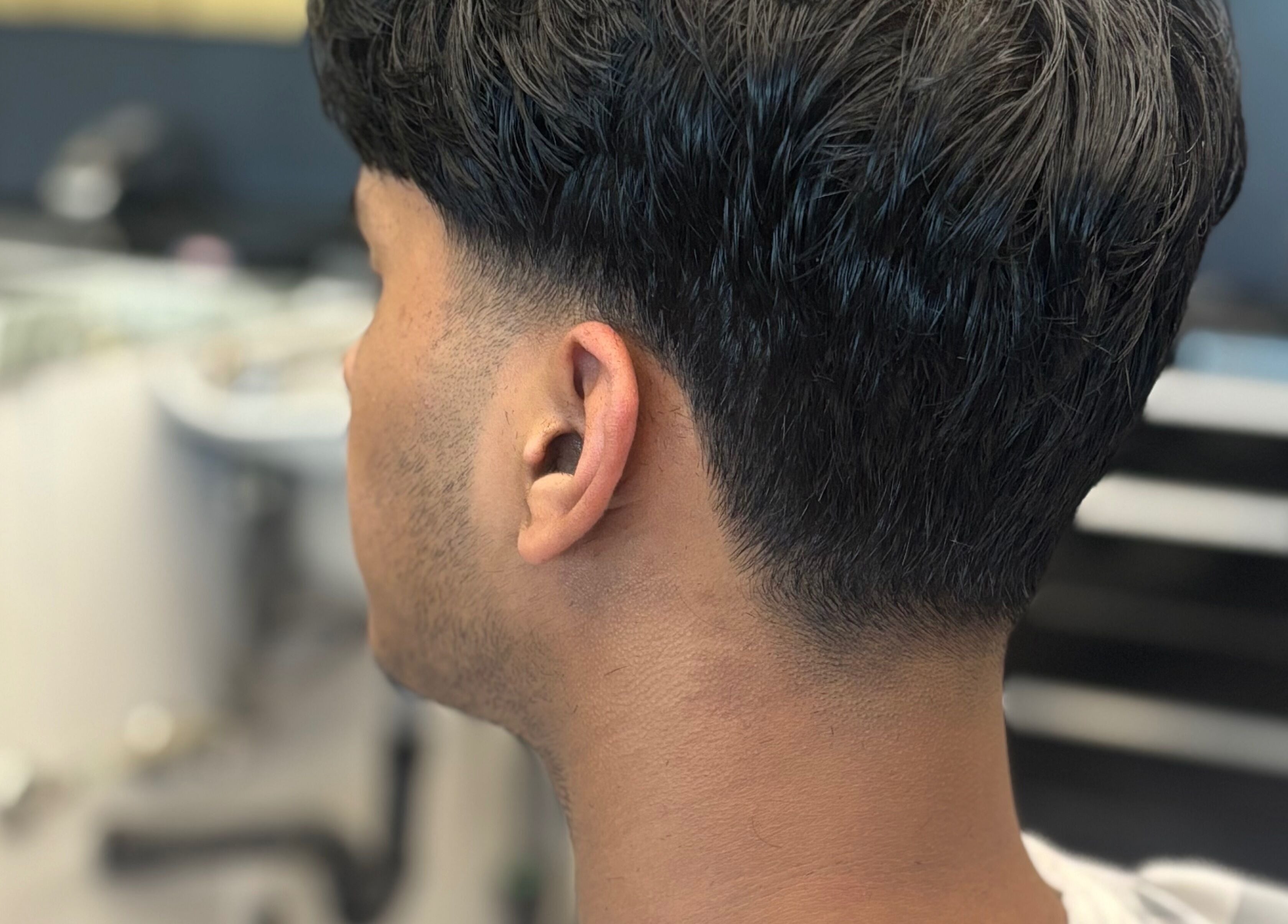 Fresh haircut at Mankind barbershop, Calgary, Alberta, CA, showcasing detailed grooming skills.