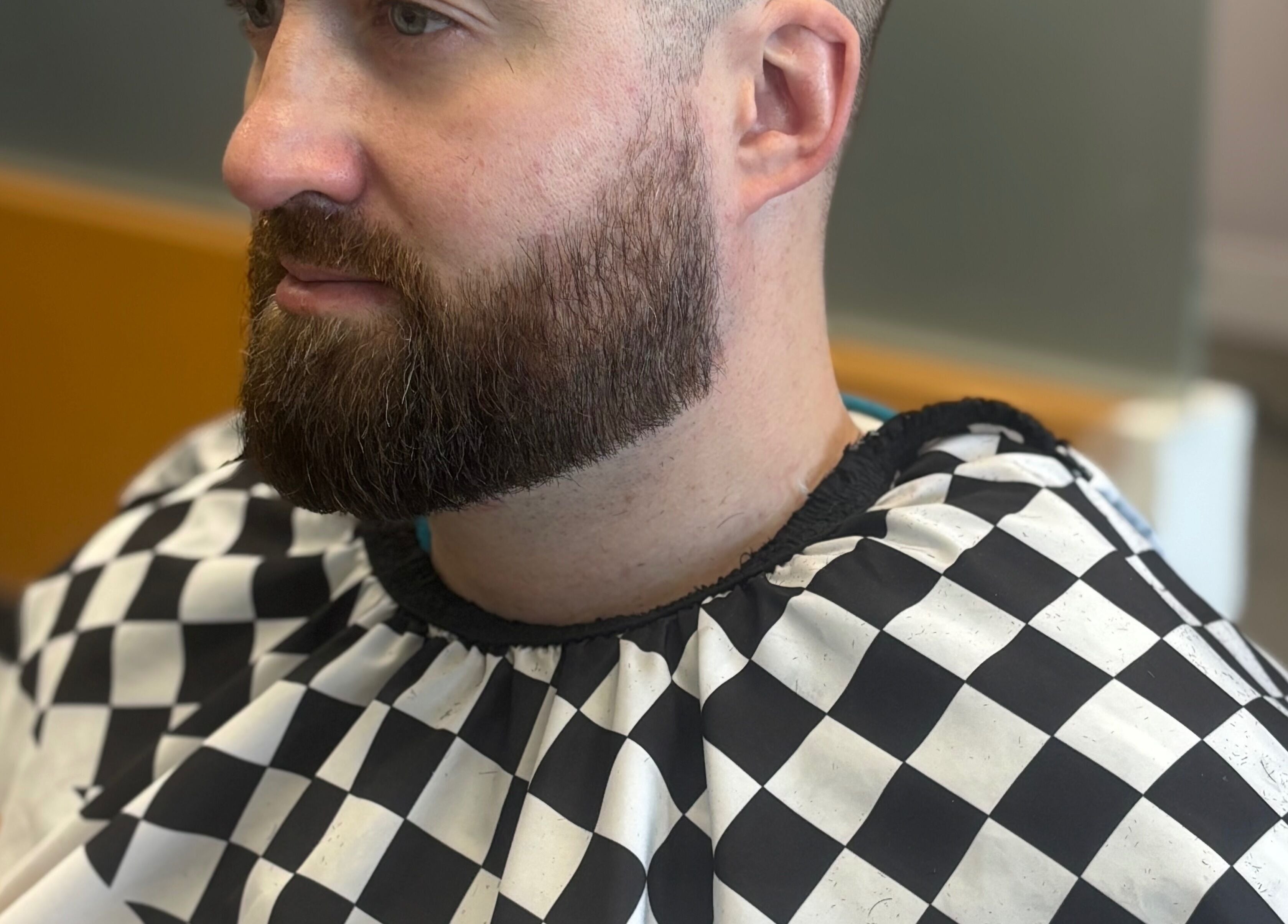 Man with trimmed beard at Mankind barbershop, Calgary, Alberta, CA.