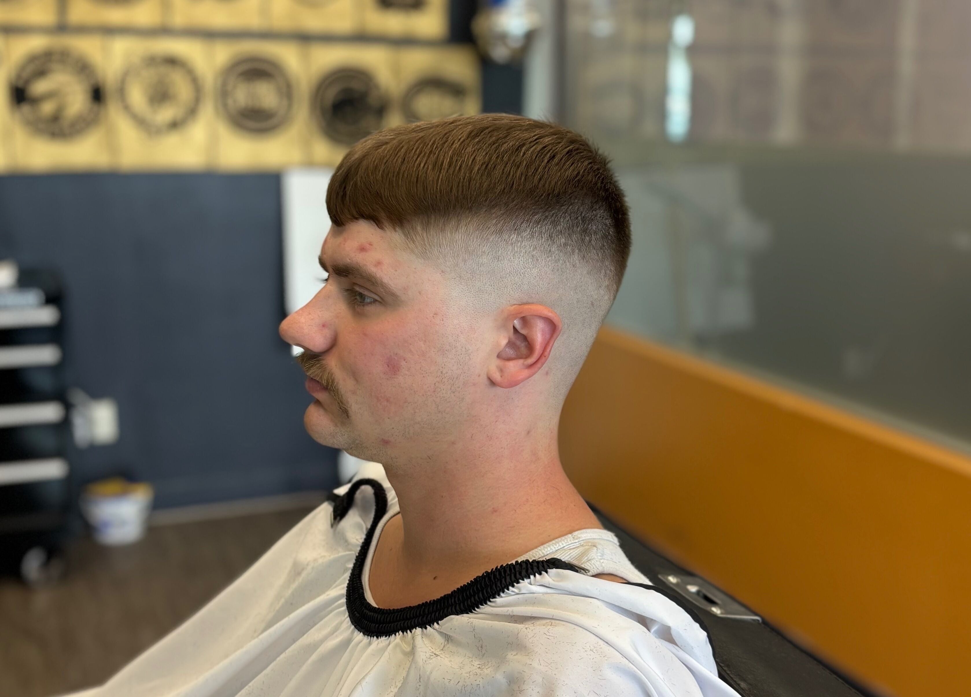 Customer with a fresh fade haircut at Mankind barbershop, Calgary, Alberta, CA.
