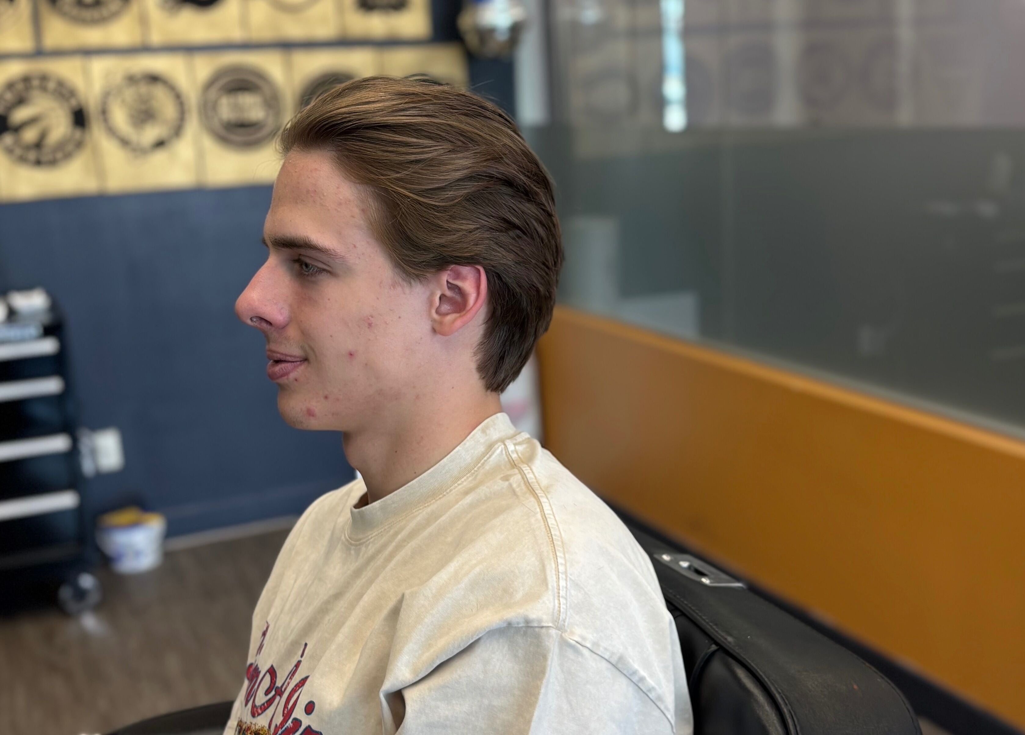 Man with stylish haircut at Mankind barbershop, Calgary, Alberta, CA. Trendy and relaxed atmosphere.