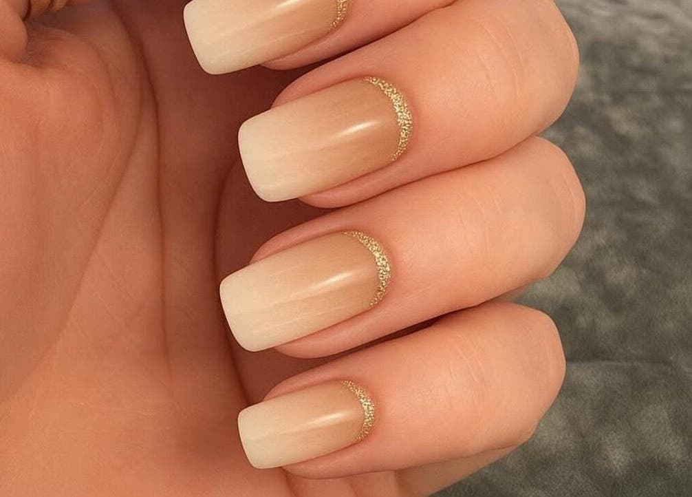 Elegant manicured nails with gold accents at Mobile Glam, Caerphilly, Wales, GB.