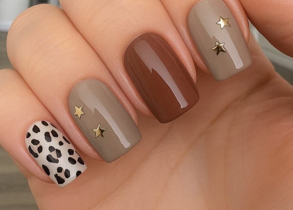 Stylish nail art with star and leopard design at Mobile Glam, Caerphilly, Wales, GB.