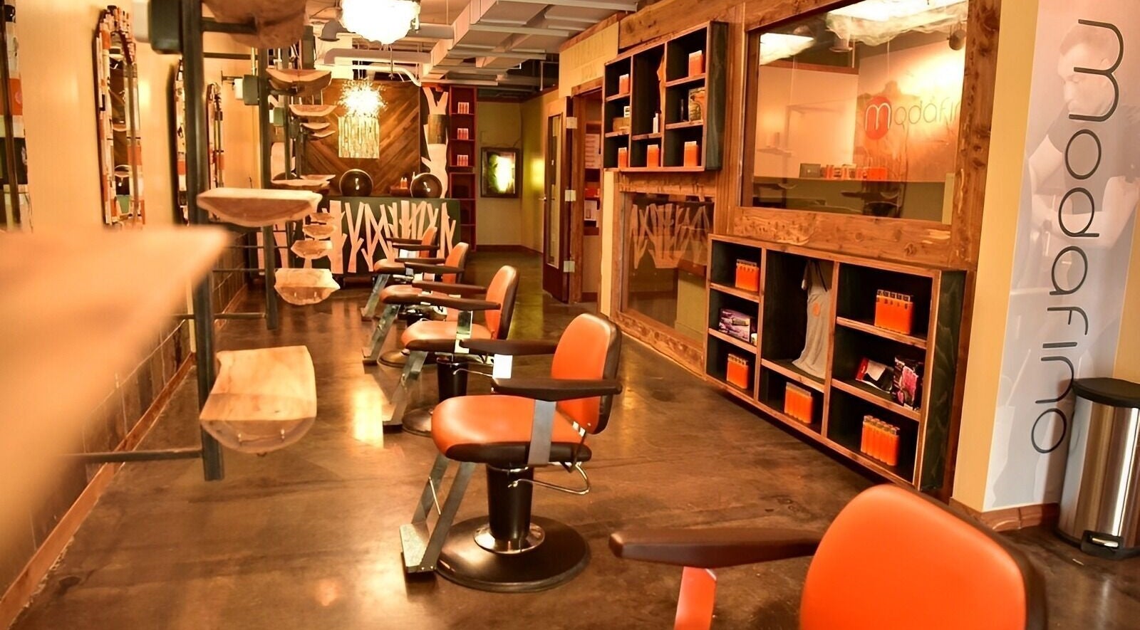 Sophisticated salon interior at Modafino, Lincoln, Nebraska, US, with modern chairs and shelving.