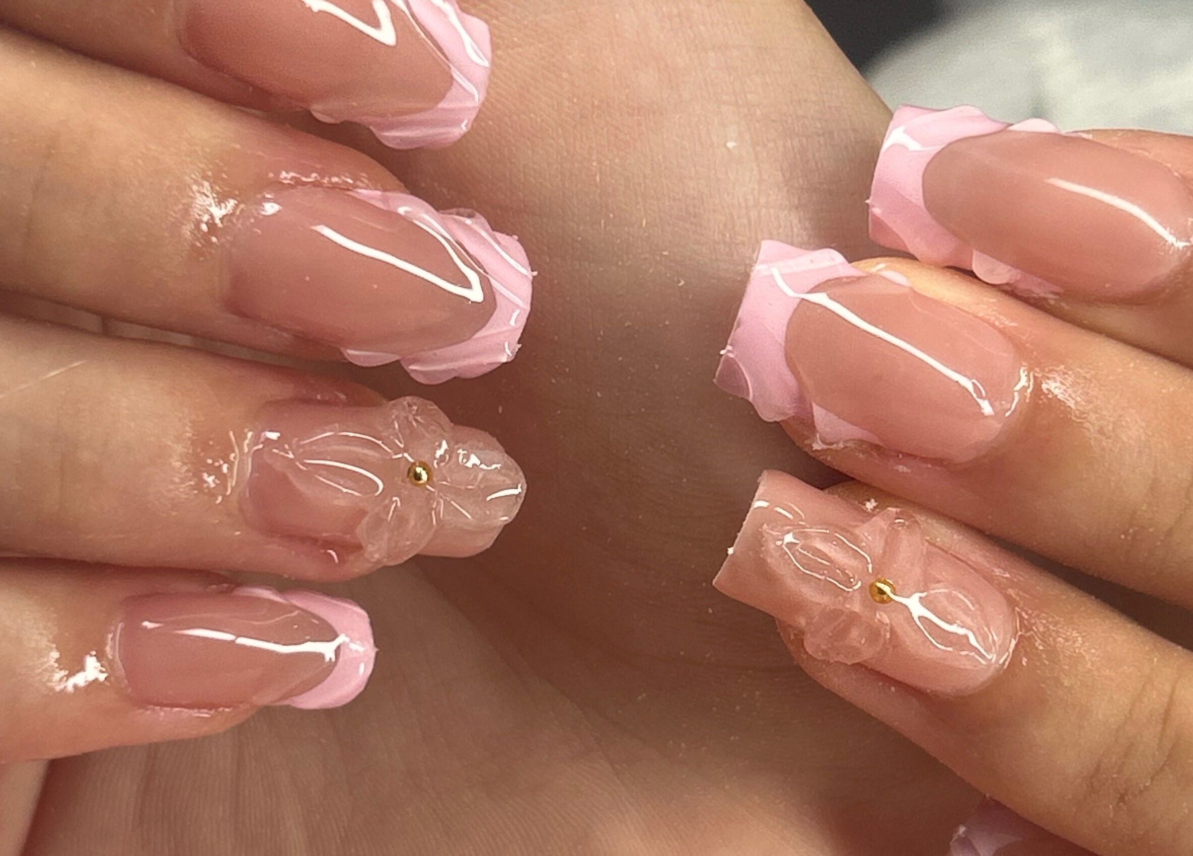 Elegant pink floral nails at arushisnails, Crawley, England, GB. Perfectly styled for beauty and sophistication.