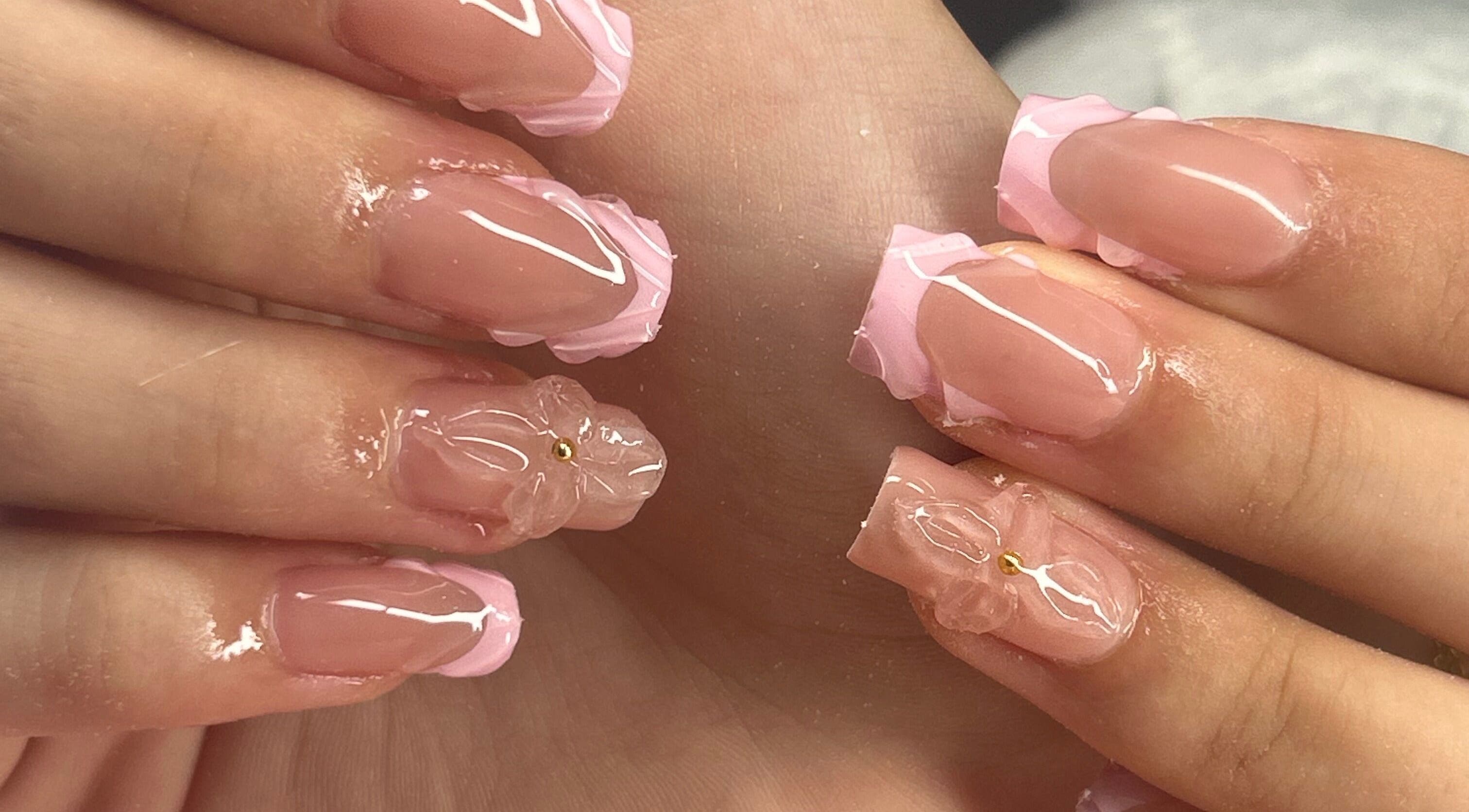 Elegant pink floral nails at arushisnails, Crawley, England, GB. Perfectly styled for beauty and sophistication.