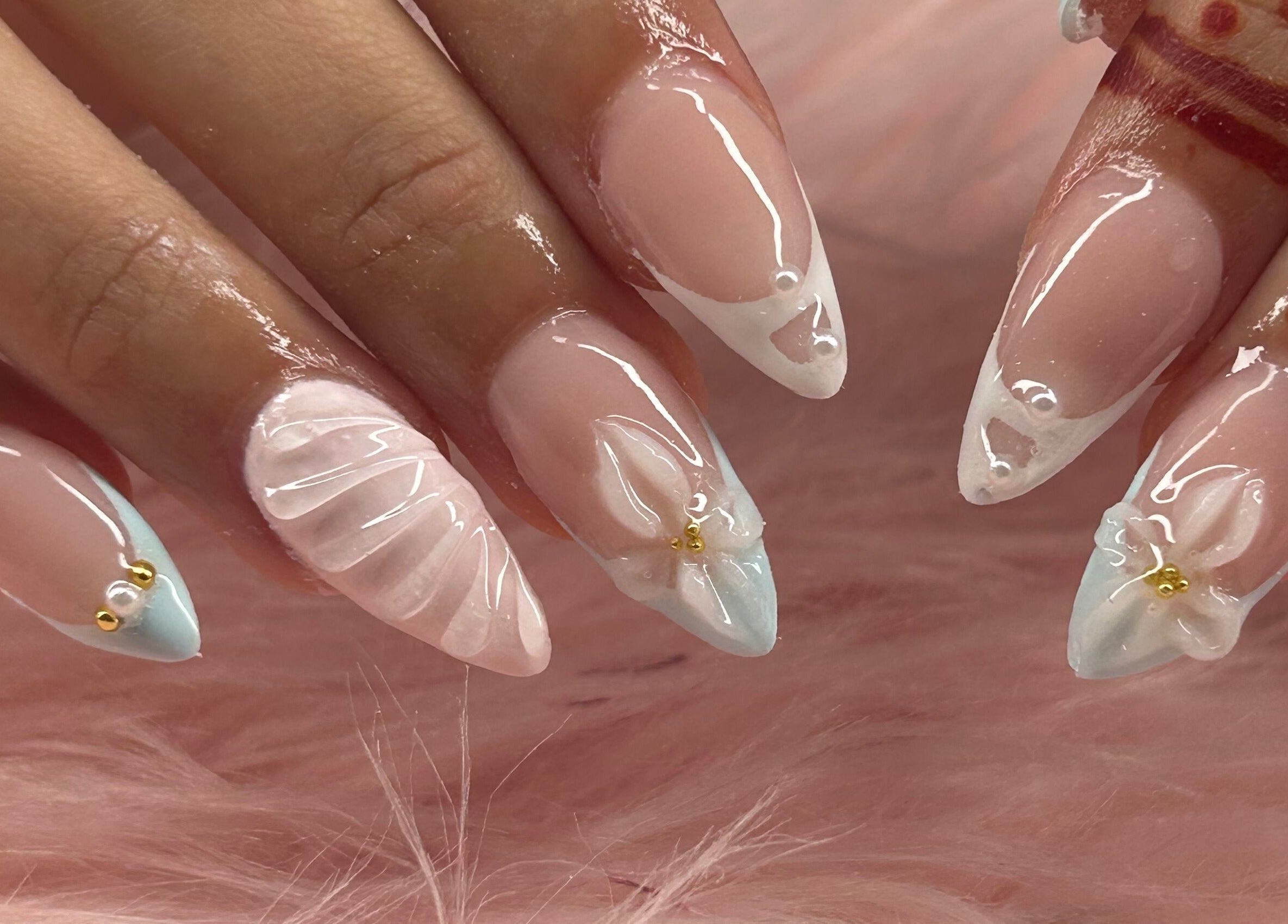 Intricate nail art on fingers with floral design at arushisnails, Crawley, England, GB.