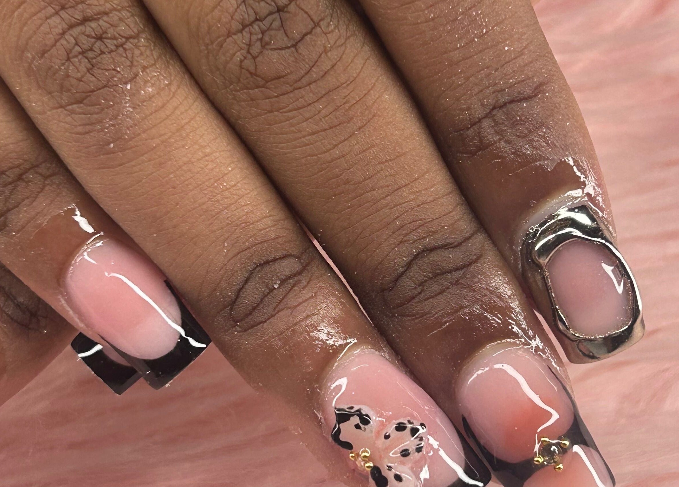 Elegant nail designs at arushisnails in Crawley, England, GB showcasing intricate black and silver accents.