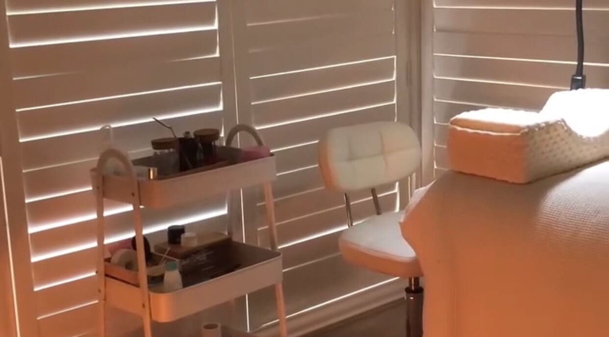 Cozy treatment space at Lollie Lash Lounge, Upper Coomera, Queensland, AU, featuring a comfortable chair and cart.