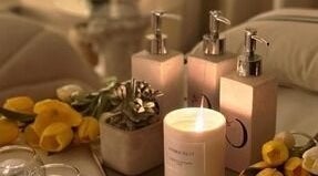 Relaxing spa setup with candles and flowers at Chamomile Spa | كامومايل هوم سبا, Riyadh, Eastern Province, SA.