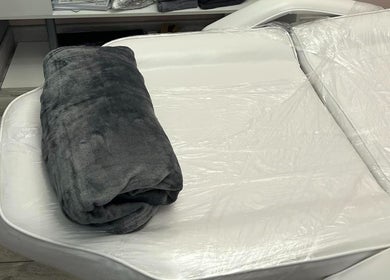 Cozy treatment bed at Lina Holistics & Beauty in Stoke-on-Trent, England, ideal for relaxation.