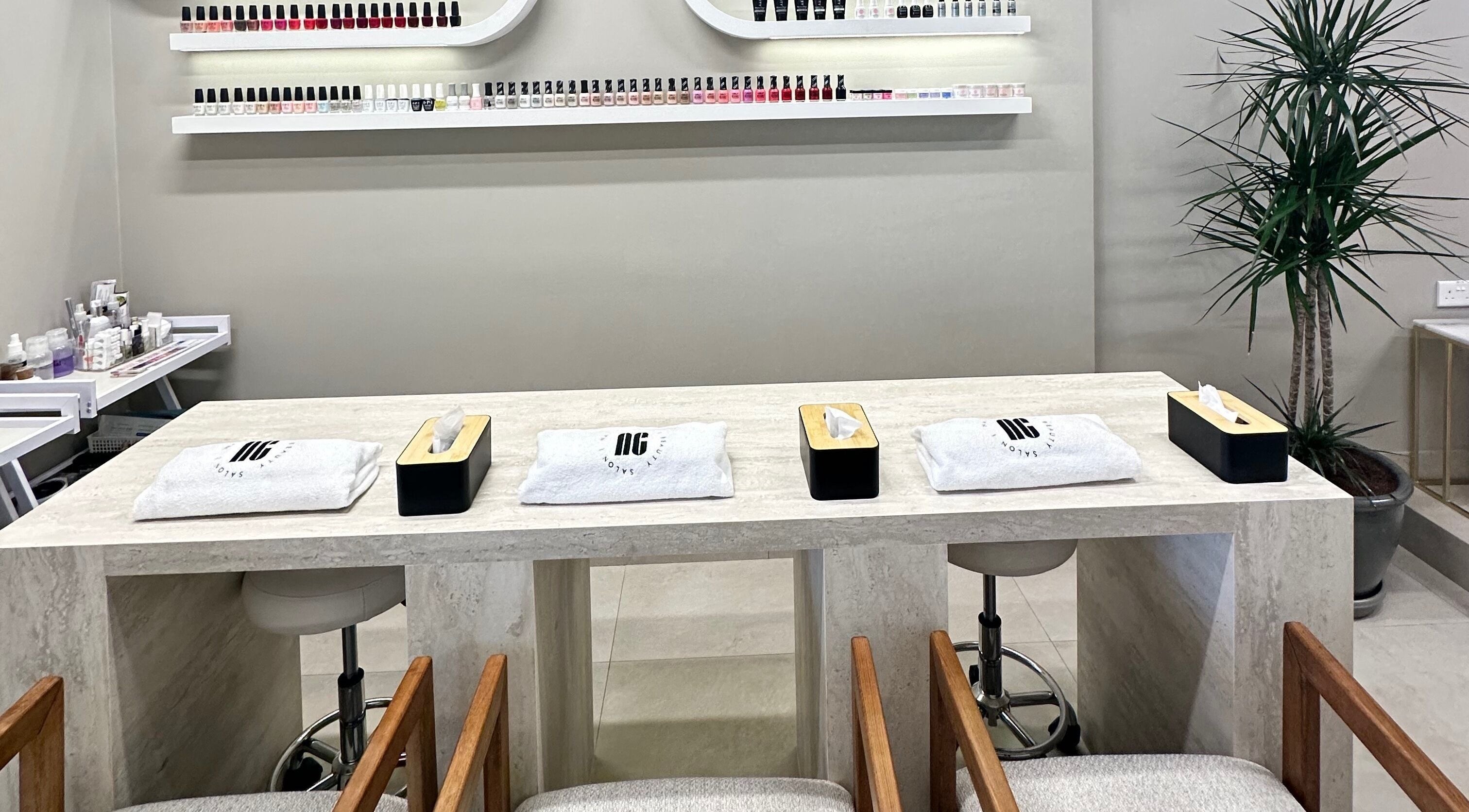 Modern manicure station at Nail Chic Beauty Salon in Dubai, Dubai, AE with elegant decor and nail polish display.