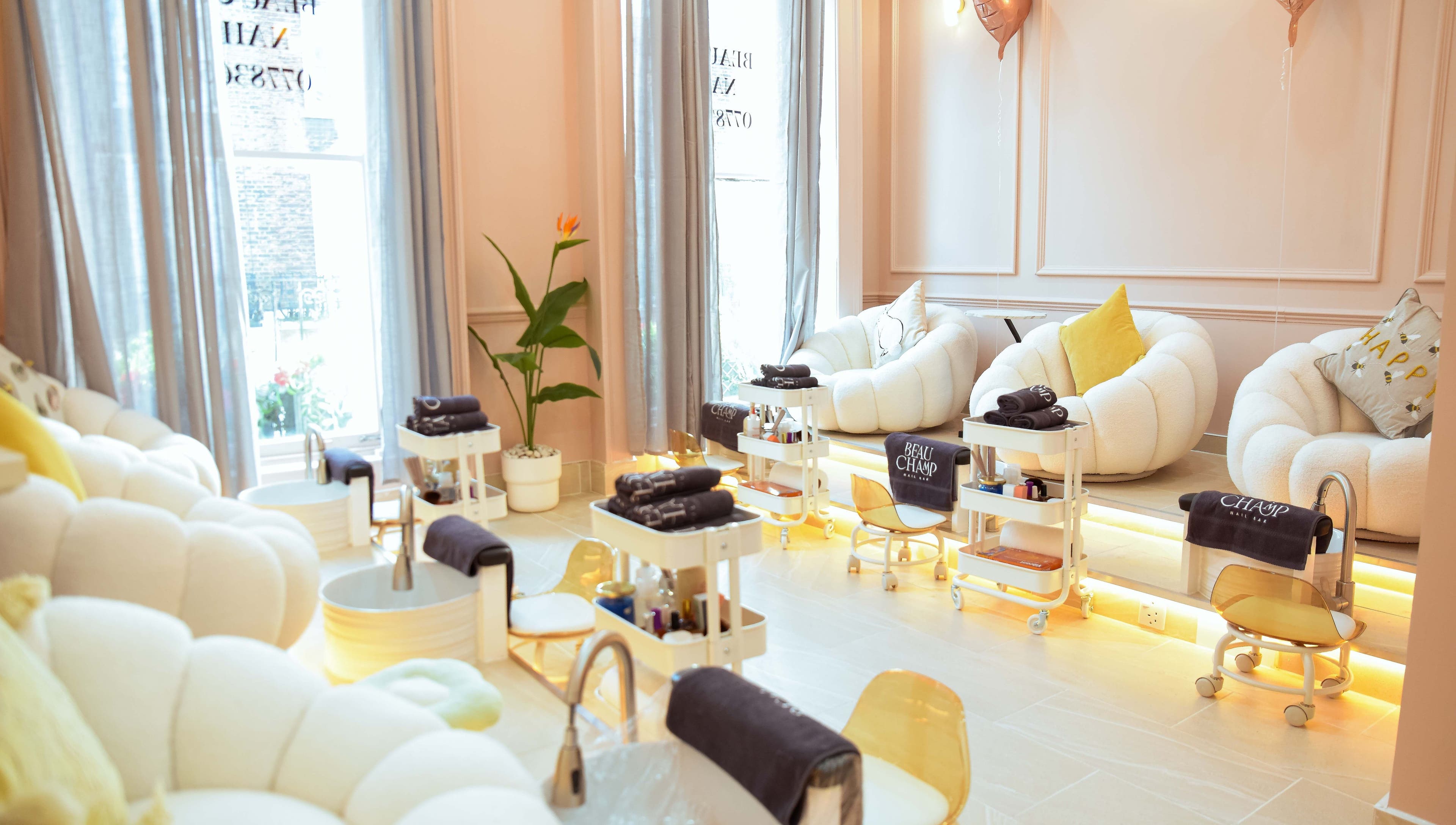 Elegant seating in Beauchamp Nails Bar, London, England, GB, with plush chairs and pedicure stations.