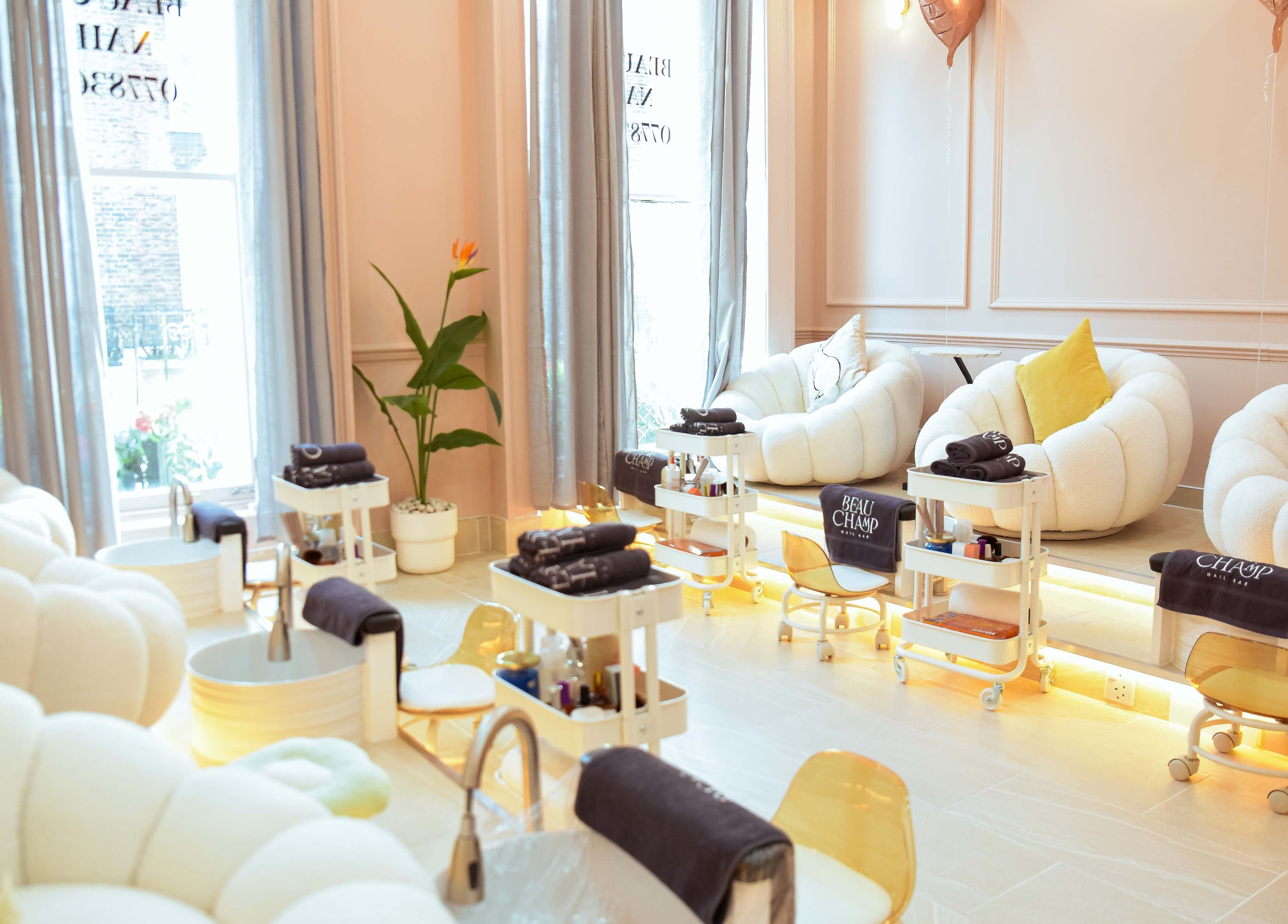 Elegant seating in Beauchamp Nails Bar, London, England, GB, with plush chairs and pedicure stations.