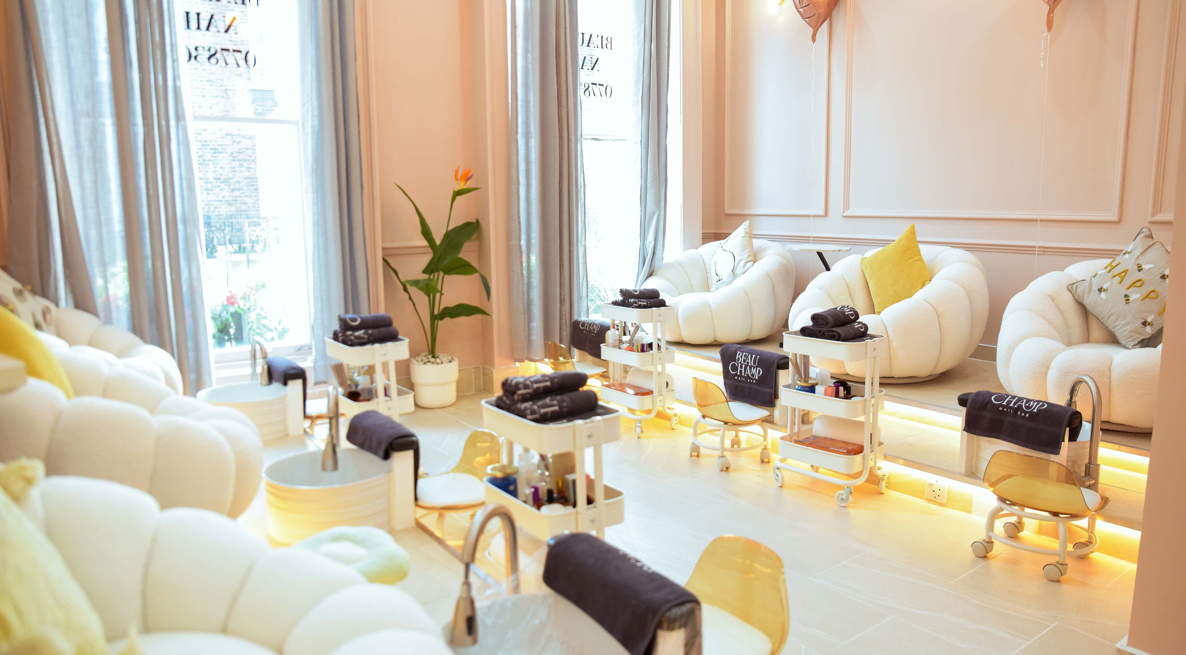 Elegant seating in Beauchamp Nails Bar, London, England, GB, with plush chairs and pedicure stations.