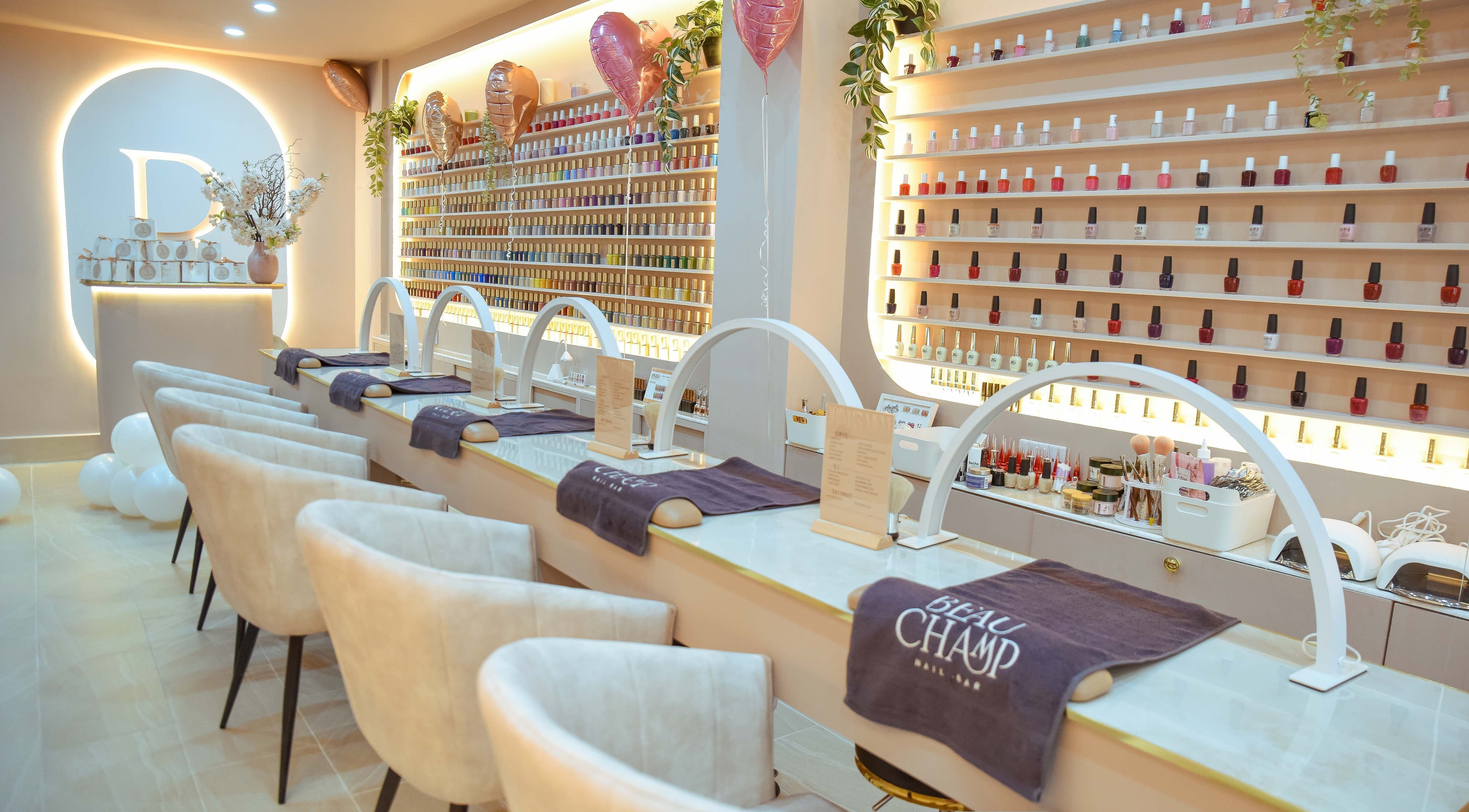 Bright, elegant interior of Beauchamp Nails Bar in London, England, GB with chic nail stations and polished decor.