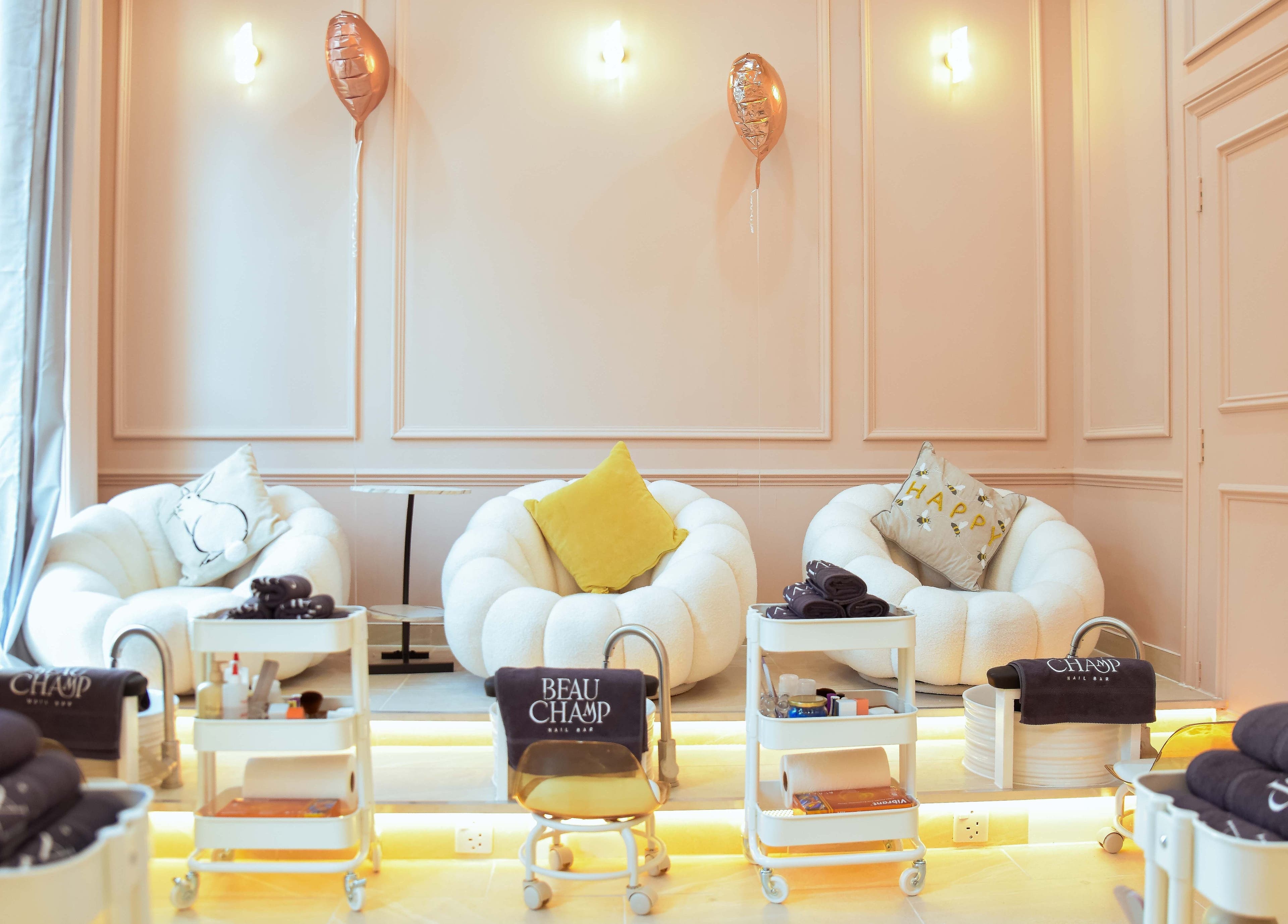 Cozy seating area at Beauchamp Nails Bar in London, England, GB with plush chairs and elegant decor.