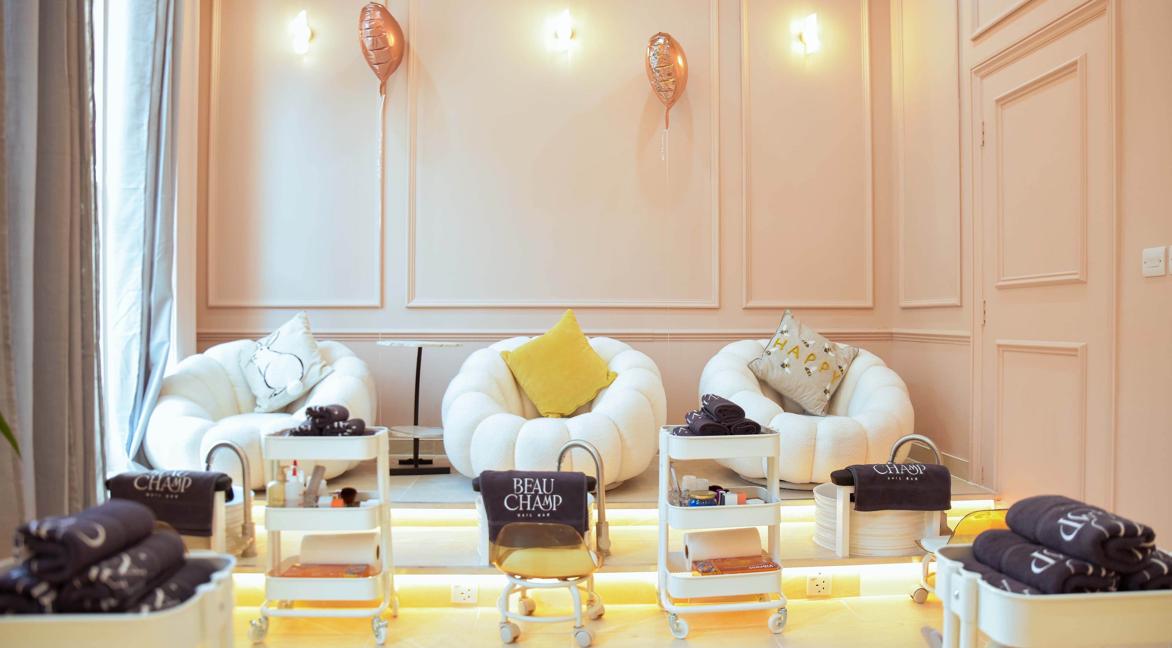 Cozy seating area at Beauchamp Nails Bar in London, England, GB with plush chairs and elegant decor.