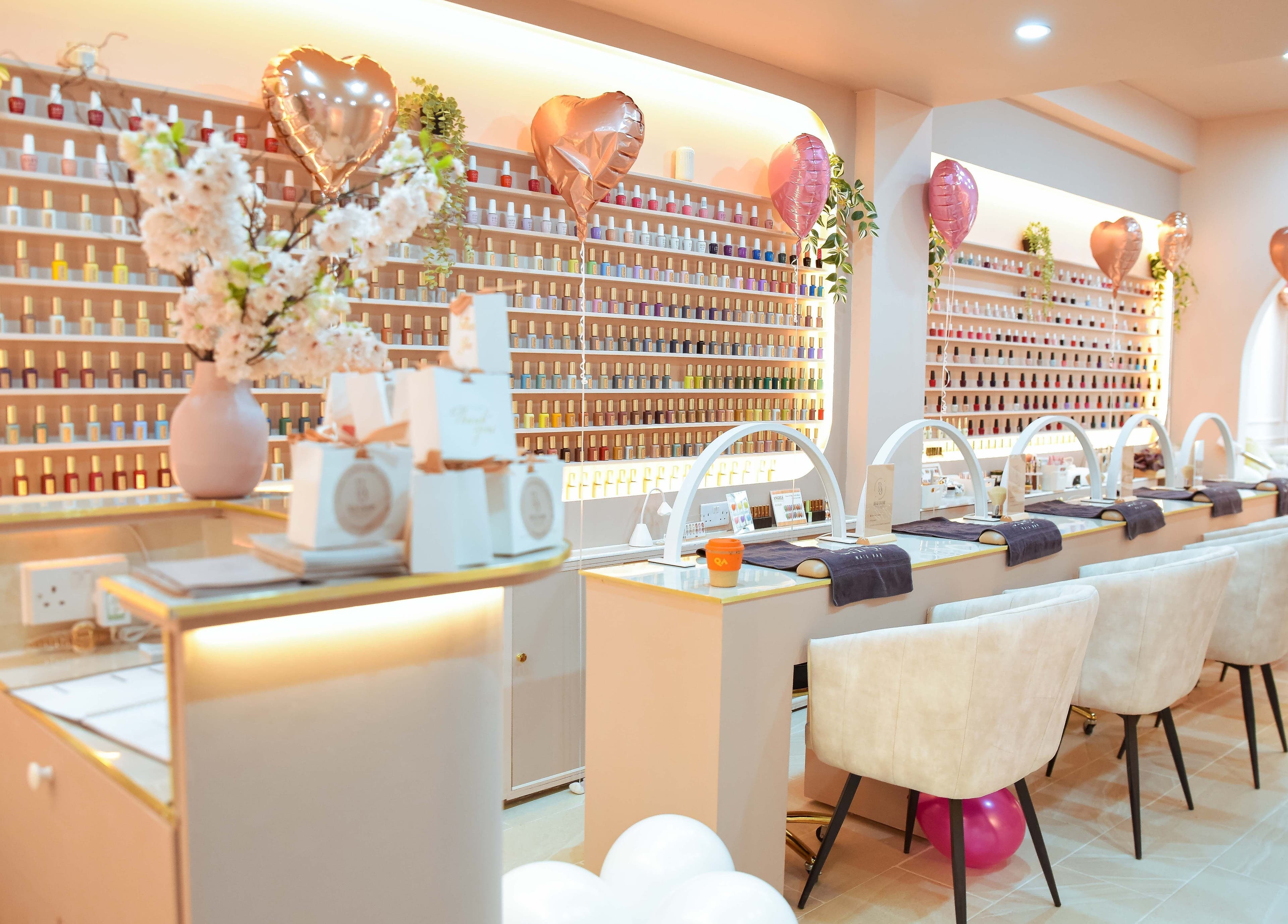 Interior view of Beauchamp Nails Bar, a chic nail salon in London, England, GB, showcasing elegant seating and nail polish display.