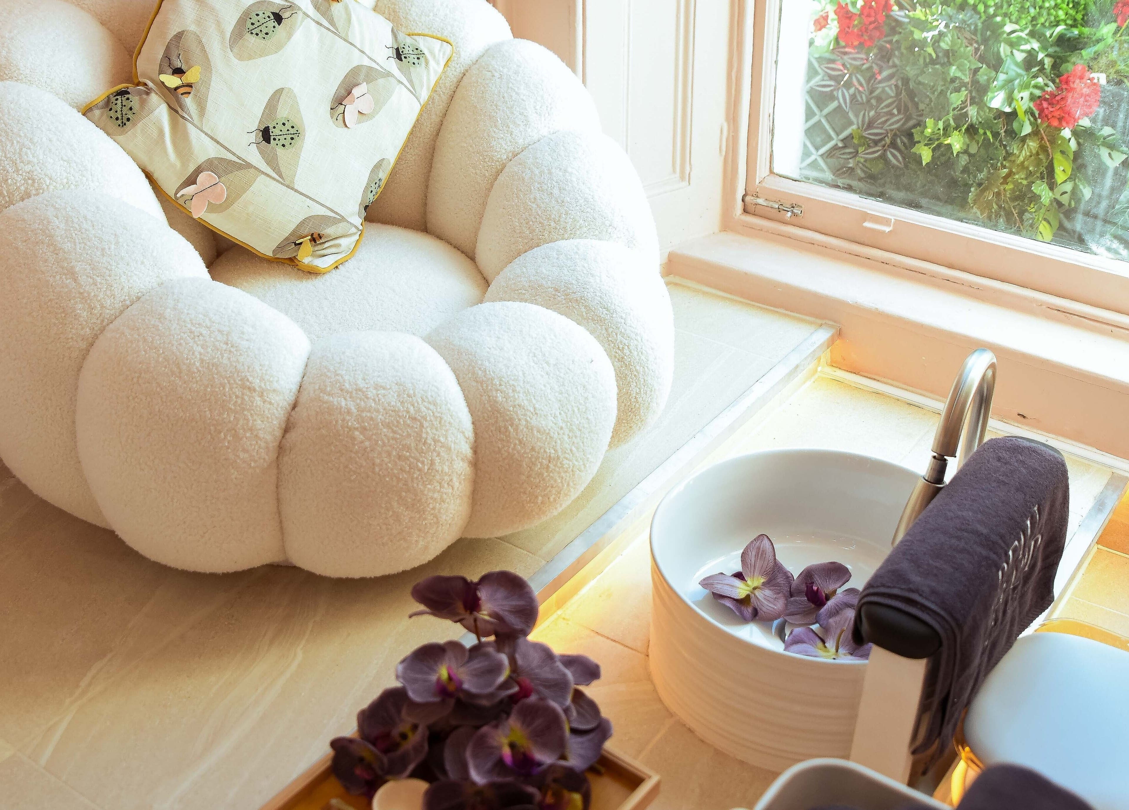 Luxurious seating area at Beauchamp Nails Bar, London, England, GB, with plush chair and foot spa setup.