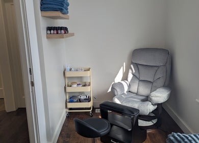 Relaxing corner at The Backdoor Wax Studio in Trail, British Columbia, CA with a plush chair and beauty products.