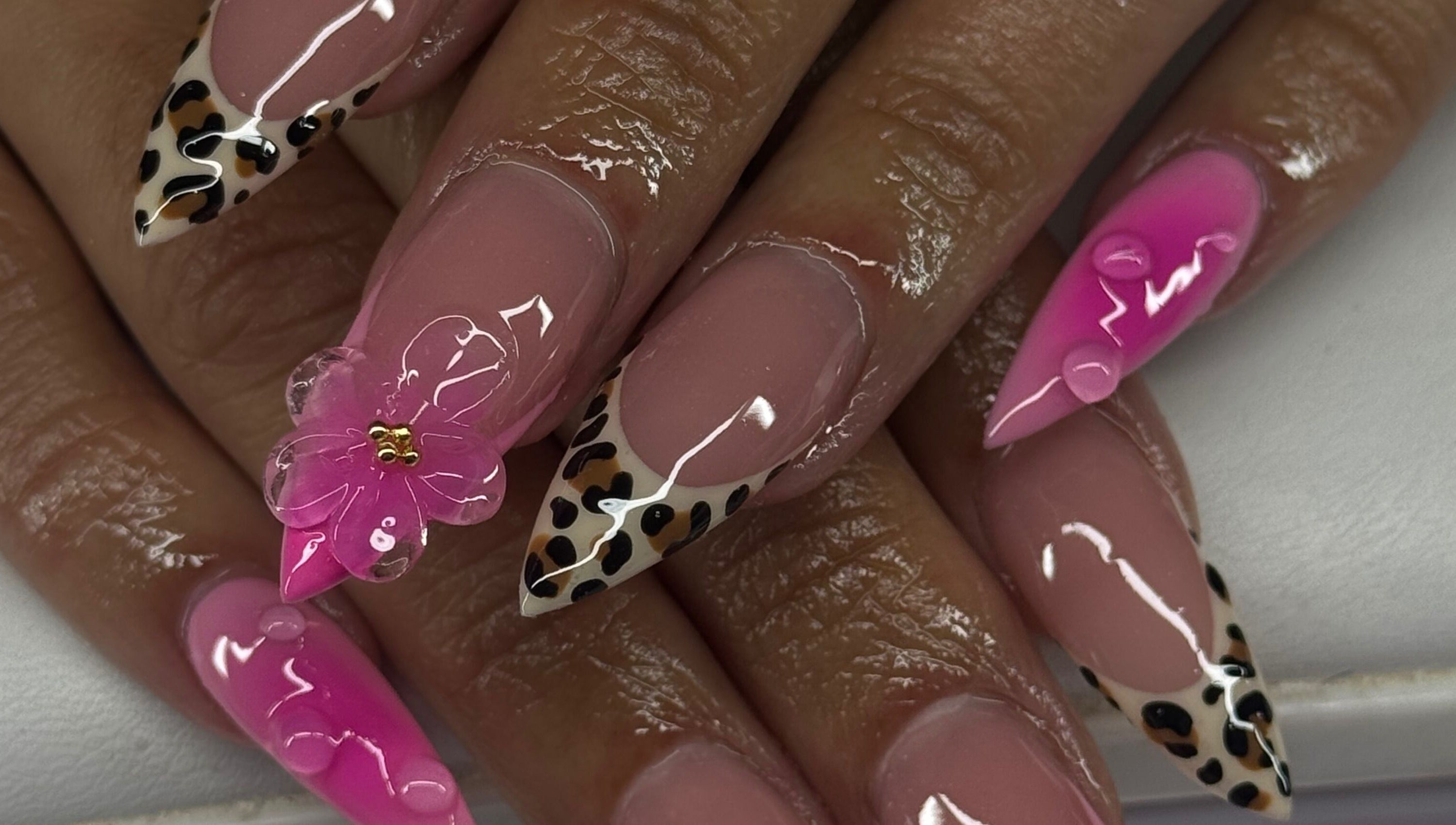 Stylish pink nails with leopard and floral design at Sets By Sam, Bell, California, US.