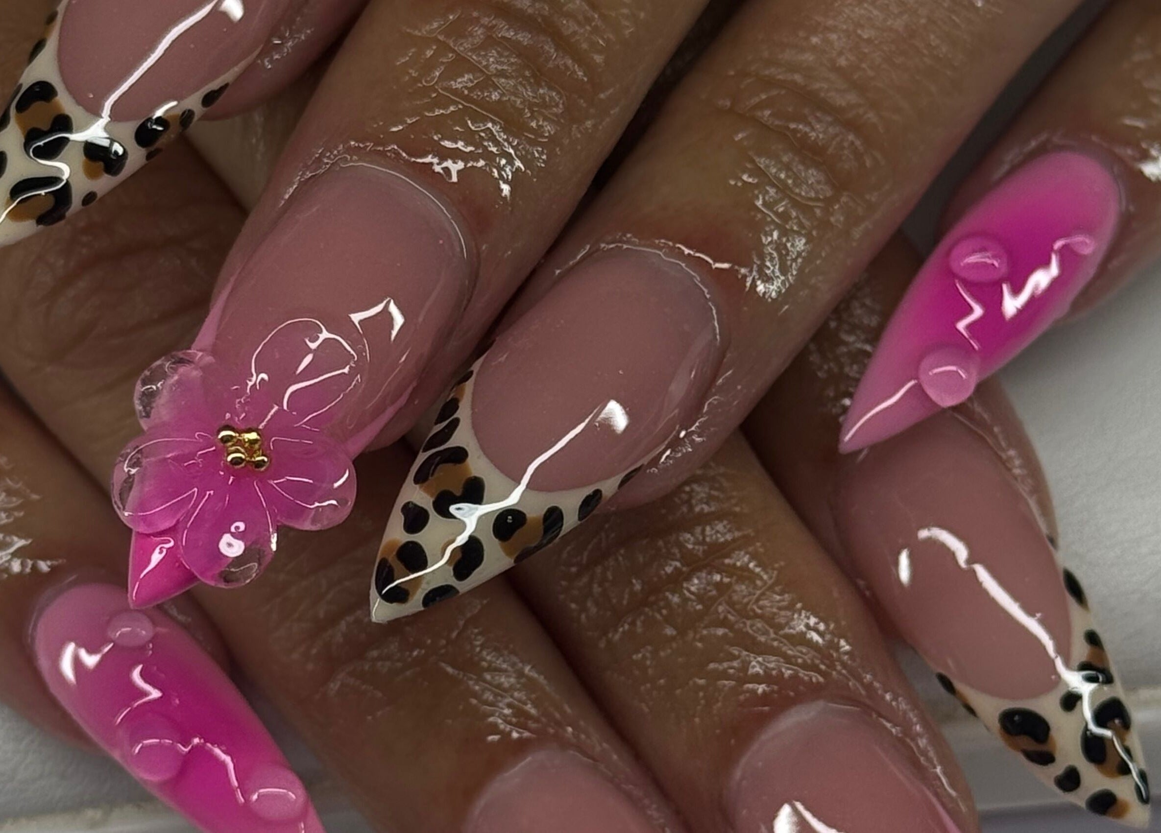 Stylish pink nails with leopard and floral design at Sets By Sam, Bell, California, US.