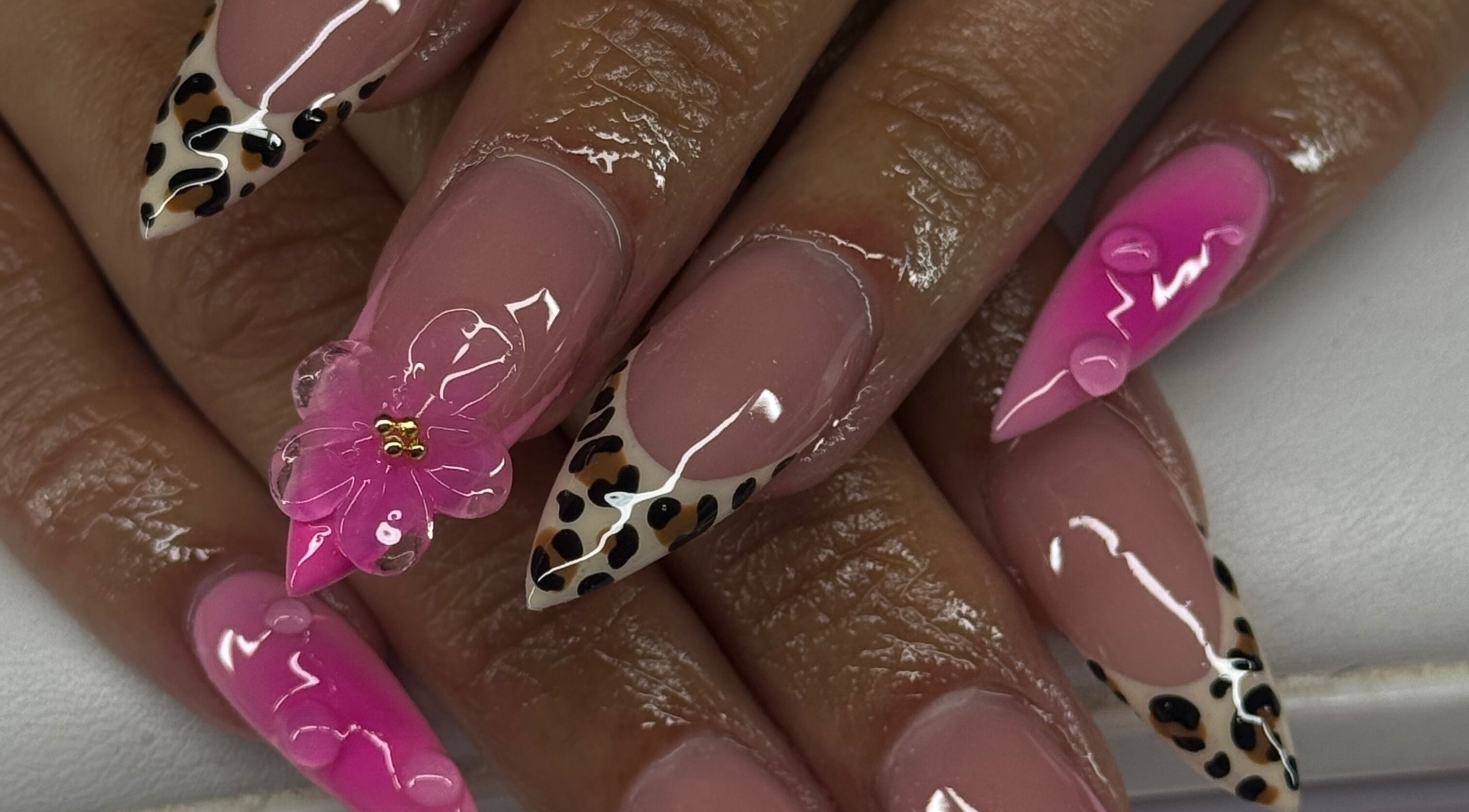 Stylish pink nails with leopard and floral design at Sets By Sam, Bell, California, US.
