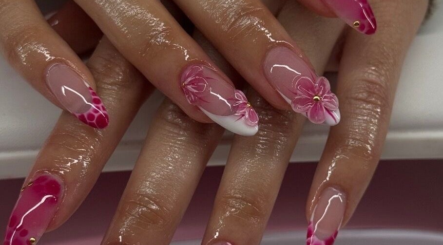 Elegant floral nail art at Sets By Sam, Bell, California, US, showcasing intricate pink designs.