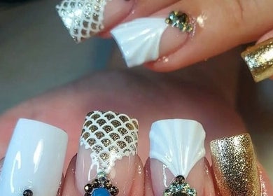 Intricate nail art with gold and white embellishments at Karissa, Grove, Oklahoma, US.