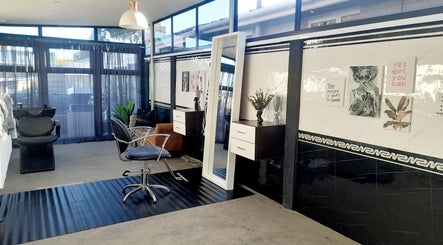 Modern salon interior at Hair by Me, Cape Town, Western Cape, ZA, featuring stylish chairs and large mirrors.
