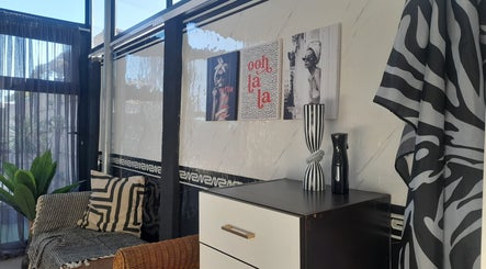 Elegant salon interior at Hair by Me, Cape Town, Western Cape, ZA, showcasing modern decor and stylish furnishings.