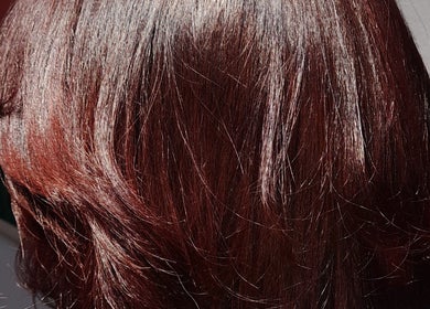 Elegant auburn hairstyle showcasing vibrant color at Hair by Me, Cape Town, Western Cape, ZA.
