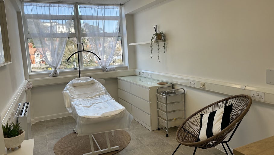 Relaxing treatment room at Aesthetics by Jade in Newton Abbot, England, GB featuring a comfortable chair and urban decor.