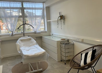 Relaxing treatment room at Aesthetics by Jade in Newton Abbot, England, GB featuring a comfortable chair and urban decor.