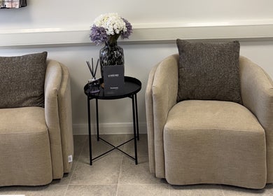 Comfortable seating area at Aesthetics by Jade, Newton Abbot, England, GB with elegant chairs and decor.